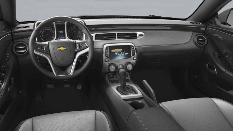 Por dentro, salvo pelo sistema multimídia MyLink, tudo é parecido com o antigo Camaro | <a href="https://preprod.quatrorodas.abril.com.br/noticias/fabricantes/chevrolet-traz-camaro-conversivel-ao-brasil-785537.shtml" rel="migration">Leia mais</a>