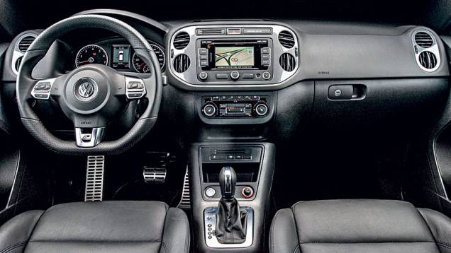 Interior possui volante de três raios com base achatada | <a href="https://preprod.quatrorodas.abril.com.br/carros/lancamentos/vw-tiguan-r-line-726908.shtml" rel="migration">Leia mais</a> Interior possui volante de três raios com base achatada | <a href="https://preprod.quatrorodas.abril.com.br/carros/lancamentos/vw-tiguan-r-line-726908.shtml" rel="migration">Leia mais</a>