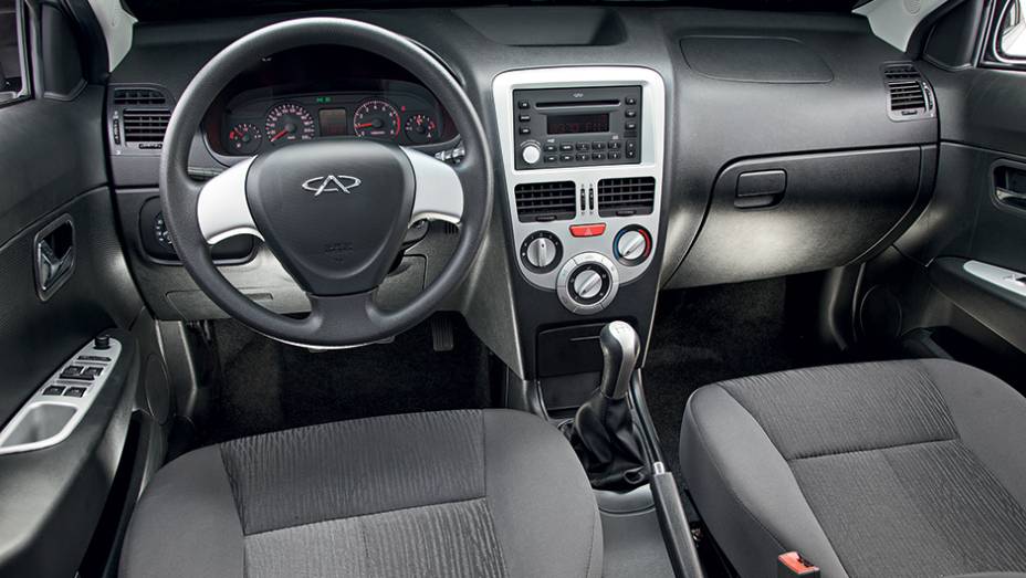 Molduras em console, volante e portas têm um tom de prata diferente do aplique do câmbio | <a href="https://preprod.quatrorodas.abril.com.br/carros/comparativos/jac-j3-1-5-s-x-chery-celer-1-5-744920.shtml" rel="migration">Leia mais</a>