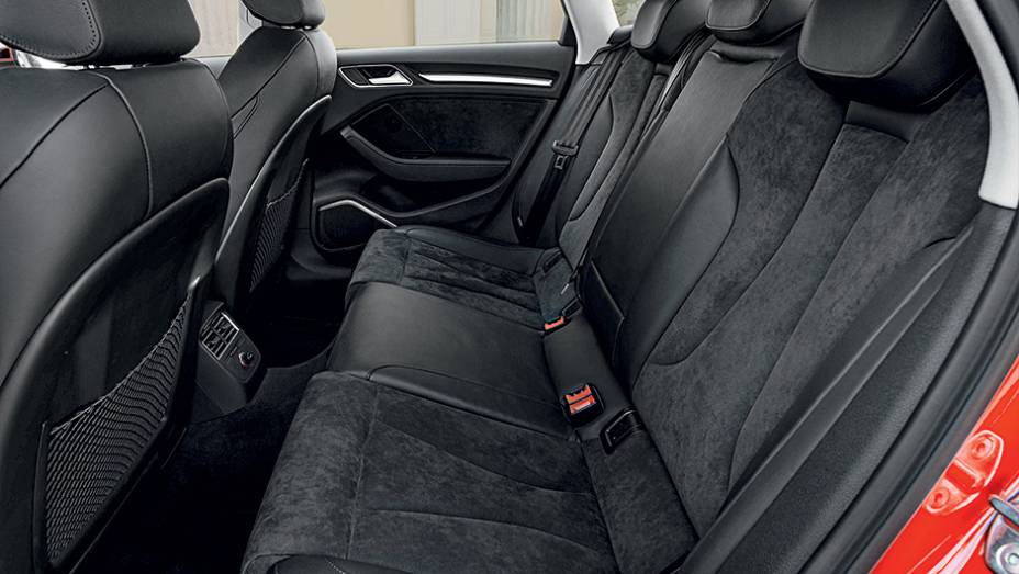 Banco traseiro pode acomodar tr&ecirc;s adultos, mas passageiro do meio sofre com o t&uacute;nel no piso | <a href="https://preprod.quatrorodas.abril.com.br/carros/impressoes/audi-a3-limousine-750333.shtml" rel="migration">Leia mais</a>