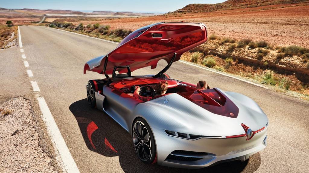 Renault Trezor com pneus Continental Renault Trezor, um carro-conceito elétrico, prateado. Ele não tem portas, uma tampa inteiriça cobre a cabine e integra o capô, vidros e teto. Pneu com faixa vermelha aparece com essa tampa aberta
