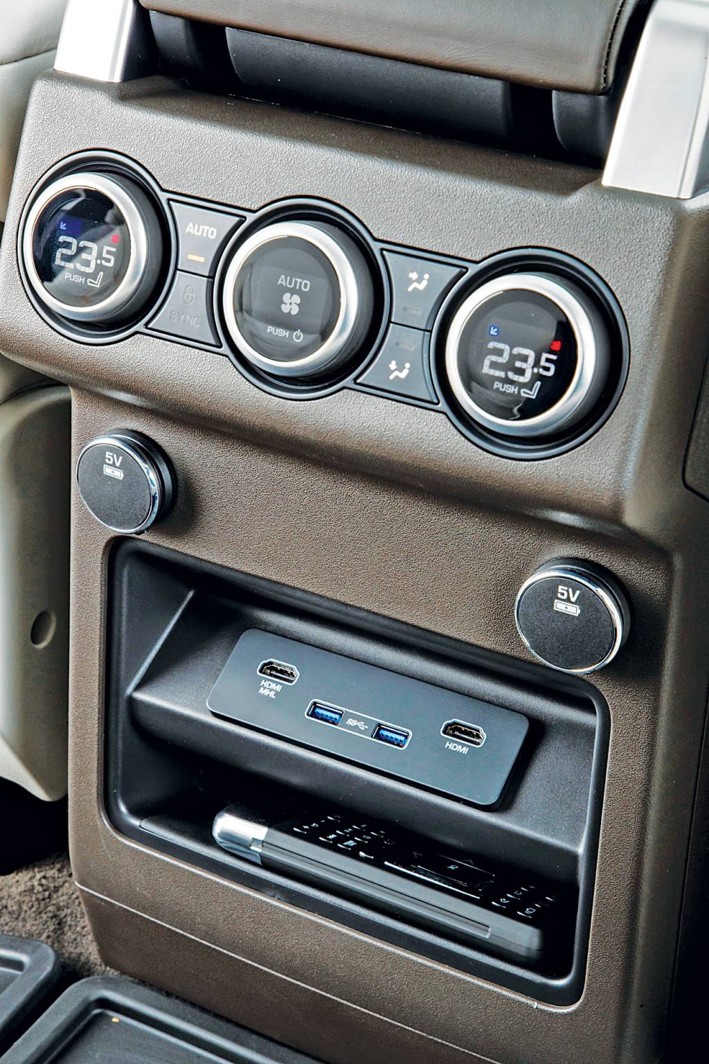 Atrás, há ajustes de ar e duas entradas USB e HDMI